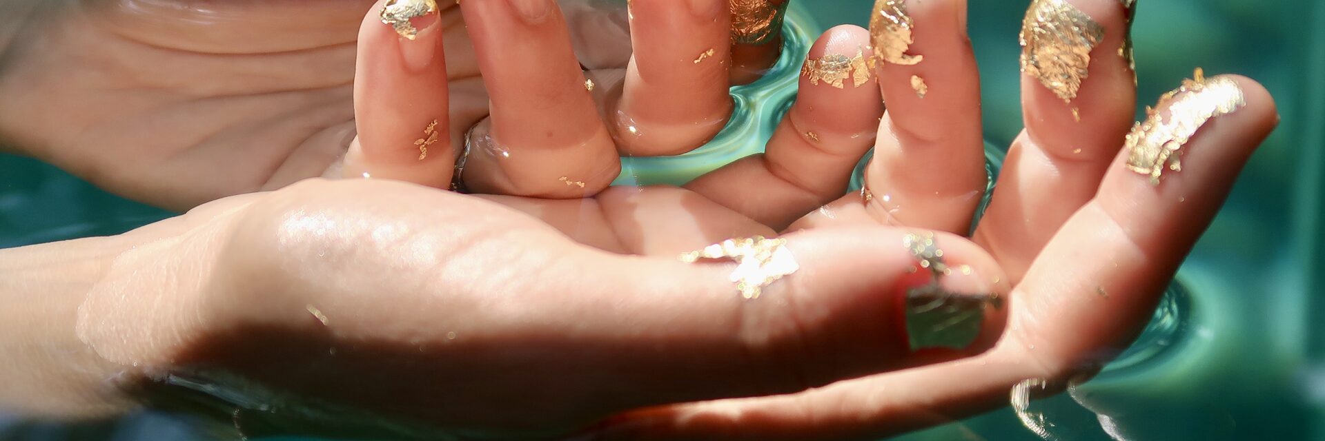 Water therapy — hands with gold leaf
